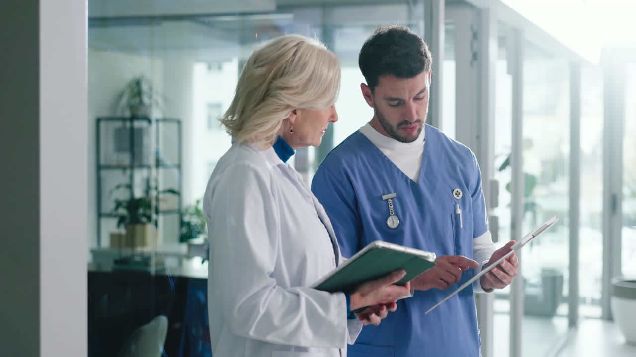 Doctors discussing patient information on a tablet
