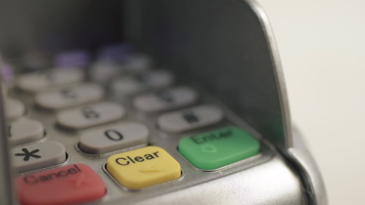 Finger tapping in pin number to pdq payment machine macro close up shot