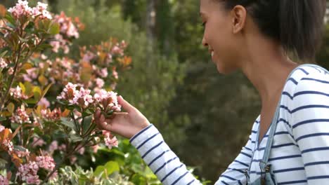 pretty young woman smelling flowers