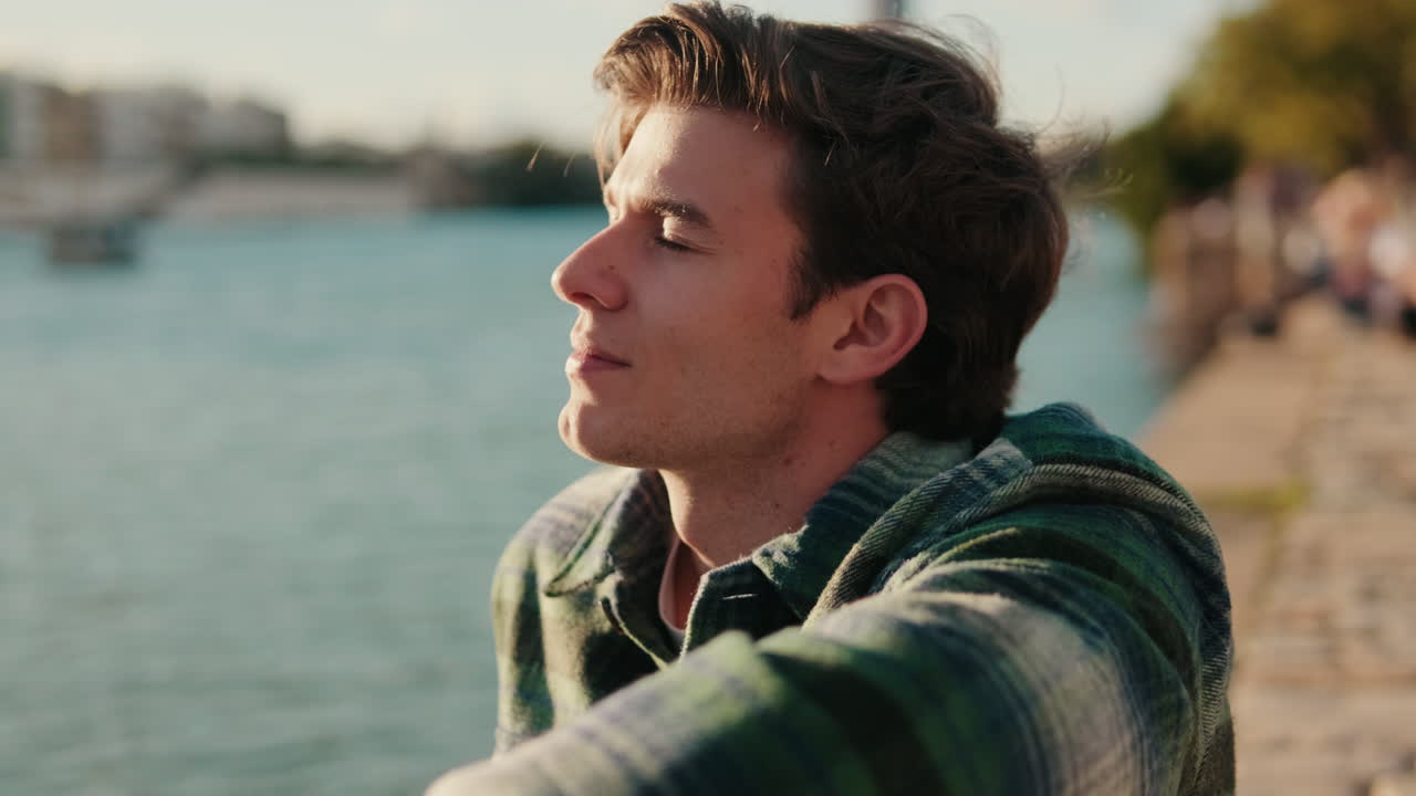 Young Man Enjoying Sunset Over Guadalquivir River