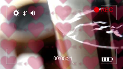 animation of hearts and frame over cup of coffee