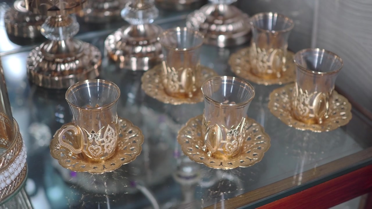 Elegant Set of Ornate Glass Tea Cups on Display