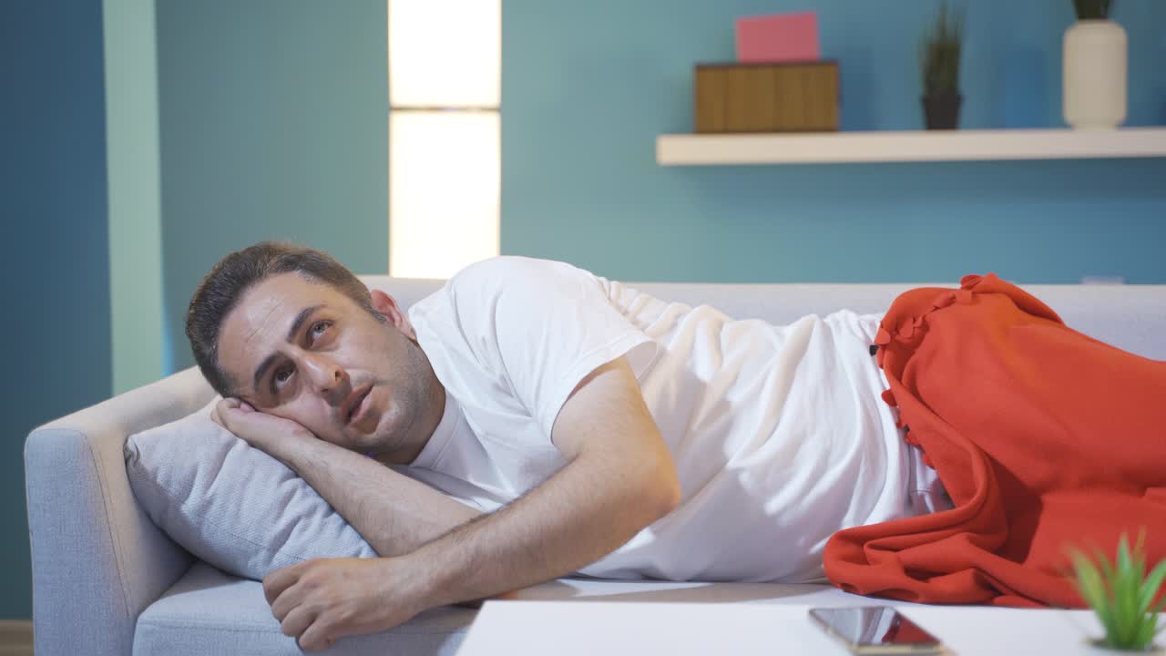 Man being thoughtful in bed.