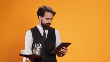 staff member prepares check on tablet