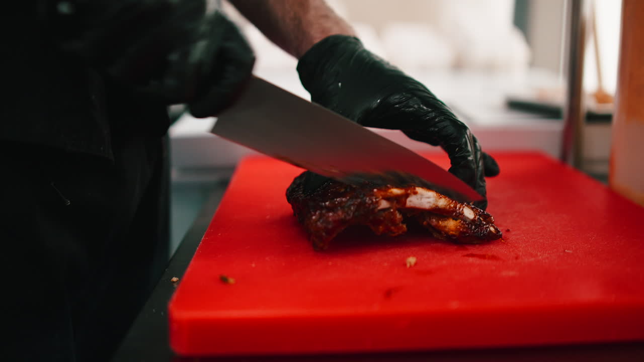 Cutting meat on a red cutting board
