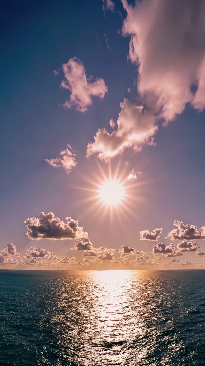 A stunning sunset over the ocean, captured from a low angle. The video style highlights the sun's