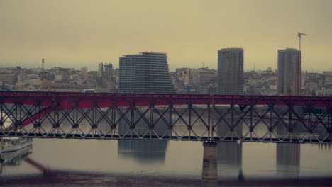 Tracking-shot-of-a-bridge-in-Belgrade-with-Belgrade-waterfront-in-background