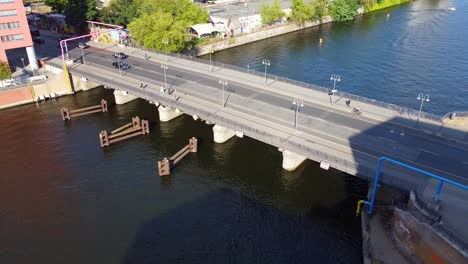 Cars-and-yellow-BVG-bus-drive-over-bridge