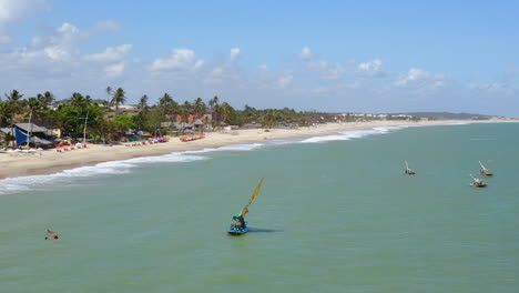 Aerial-vies-of-some-boats-browsing-by-the-sea,-Cumbuco,-Ceara,-Brazil