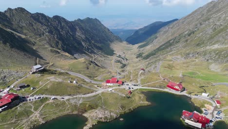 transfaragasan mountain road pass and lake balea in carpathians, transylvania, romania - aerial 4k