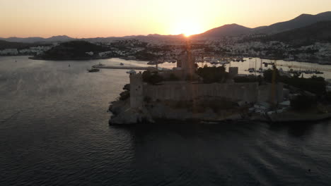 Port-with-many-ships-in-Bodrum-in-Turkey-at-sunset,-sea,-filmed-by-Drone