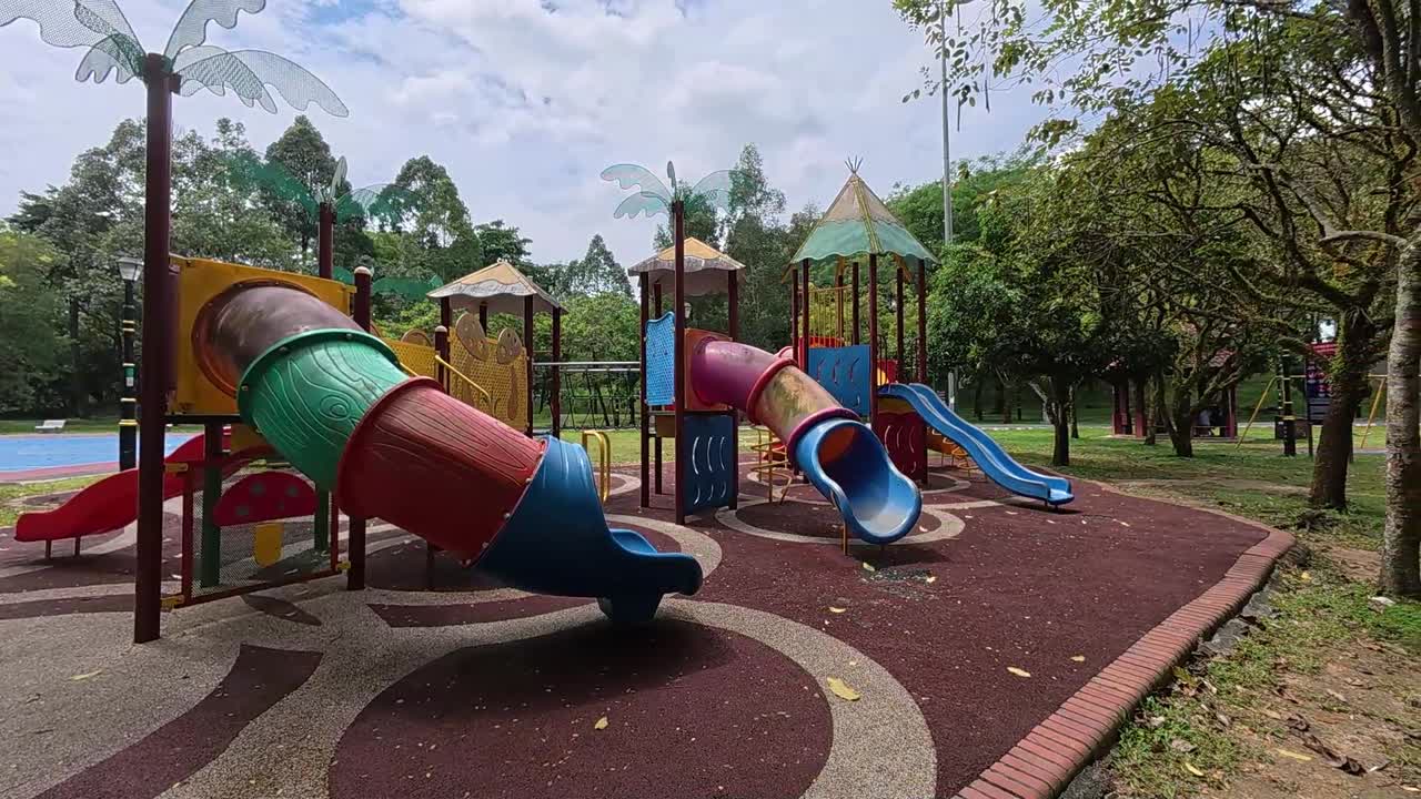 A vibrant public playground for children in a beautiful tropical park. Sunny weather enhances the cheerful outdoor atmosphere
