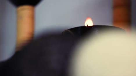 candlelight surrounded by decorative items in a wellness spa becoming gradually in focus