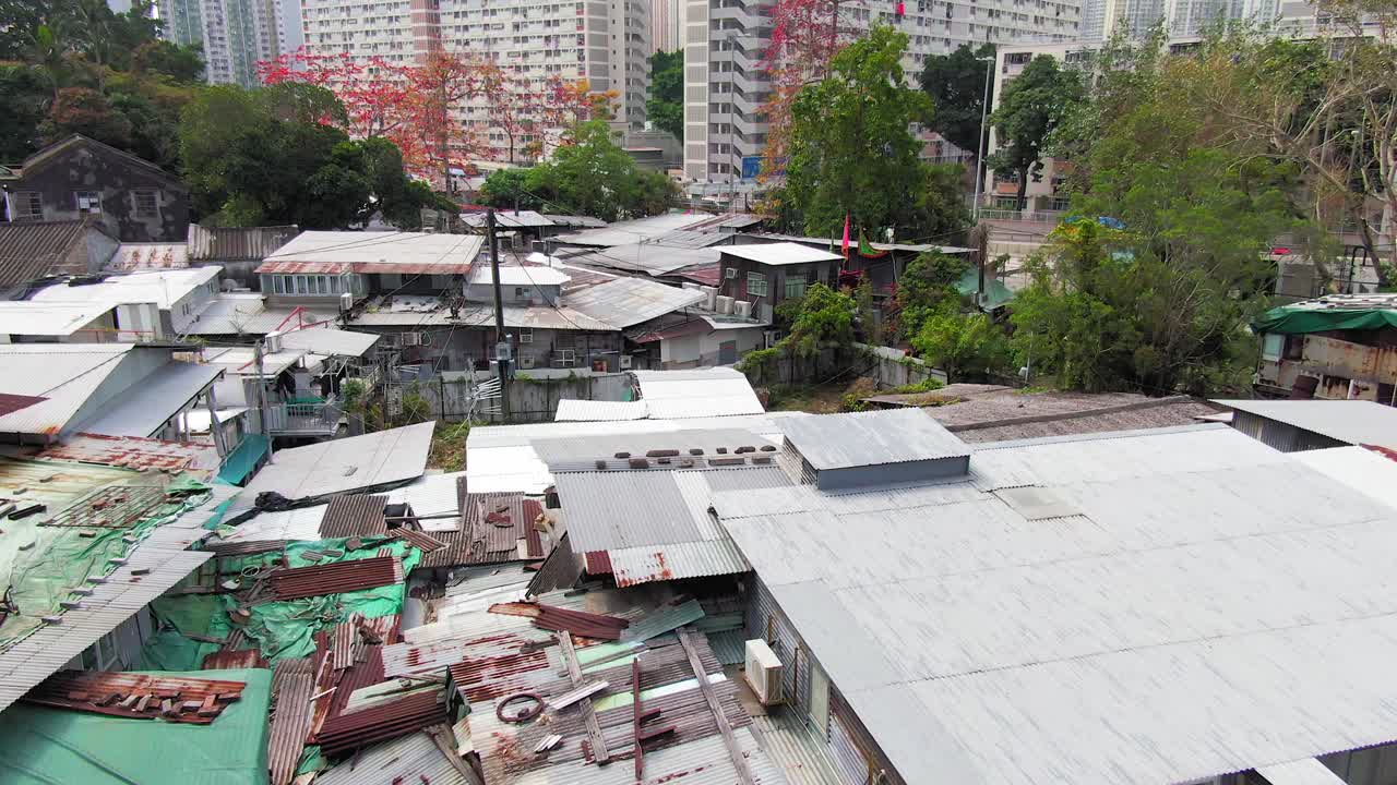 Hong Kong rundown slum houses populated by squatters, in the outskirts of Kowloon bay, low angle aerial view