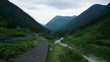 Slow-rise-above-an-avalanche-shelter-beside-a-cold-mountain-river