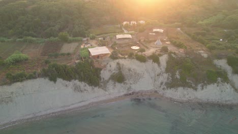 Stunning-coastline-of-Corfu-Arillas-in-Greece,-bird's-aerial-view,-golden-hour