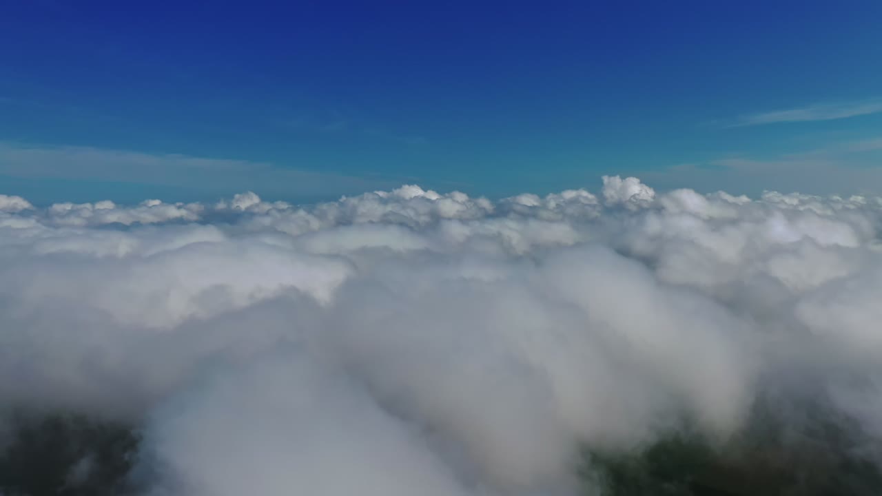 White clouds under blue sky. Stunning footage of the sky. Travelling in the cloudscape. Scenic view of the heaven. Motion to the left. Slow motion.