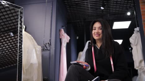 woman in bridal shop with notebook