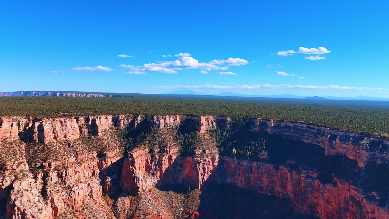 Grand Canyon rim view at sunrise. Sunrise light illuminates the canyon rim with vivid colors