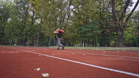 man doing fitness workout. rear view of man man training workout at race track