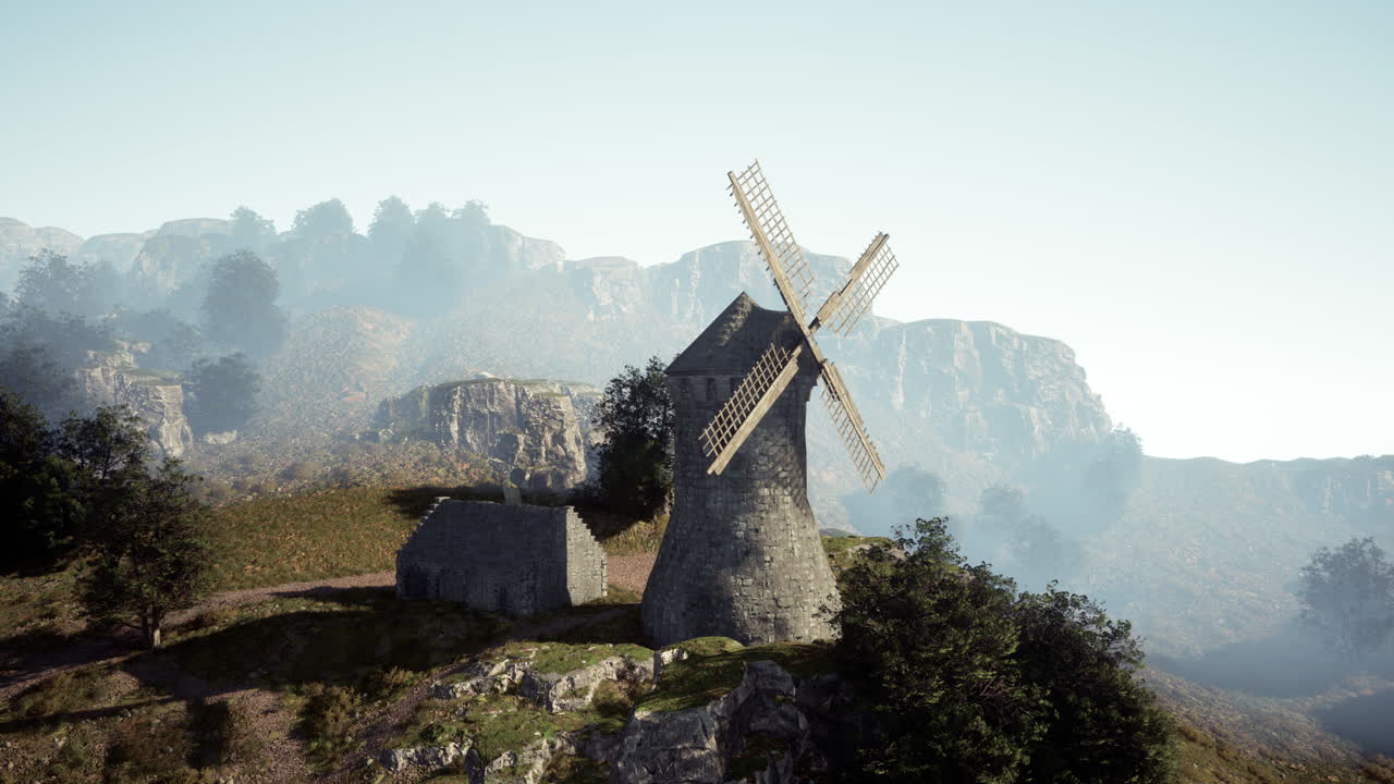 туманная горная ветряная мельница и руины