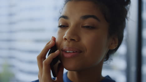 african businesswoman calling phone in office. employee talking mobile phone