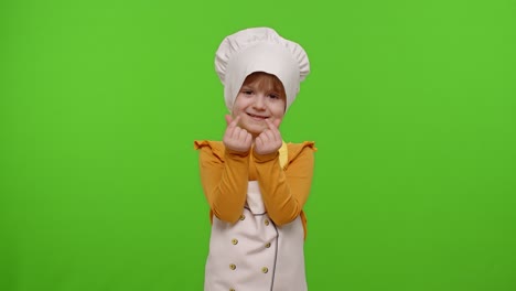 child girl dressed in apron and hat like chef cook asking to pay her money, concept of cooking store