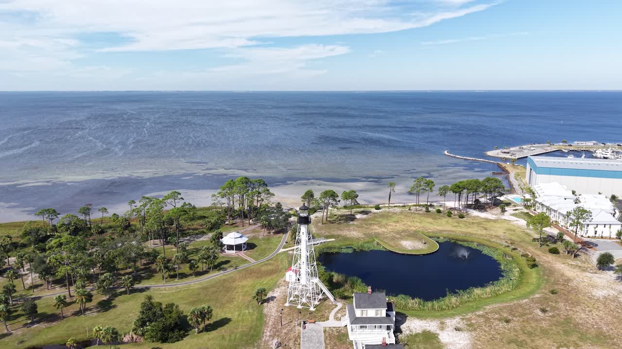 Panoramic drone fly at coastal side of Port St. Joe with Cape San Blas Lighthouse with small artificial pond, Gulf County, Florida, USA