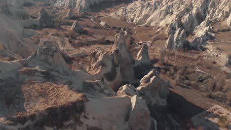 rocks formation in cappadocia, turkey. aerial tilt up