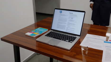 laptop and documents on a table in an office setting