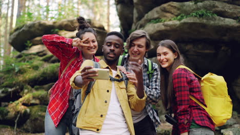 friends taking a selfie in a forest