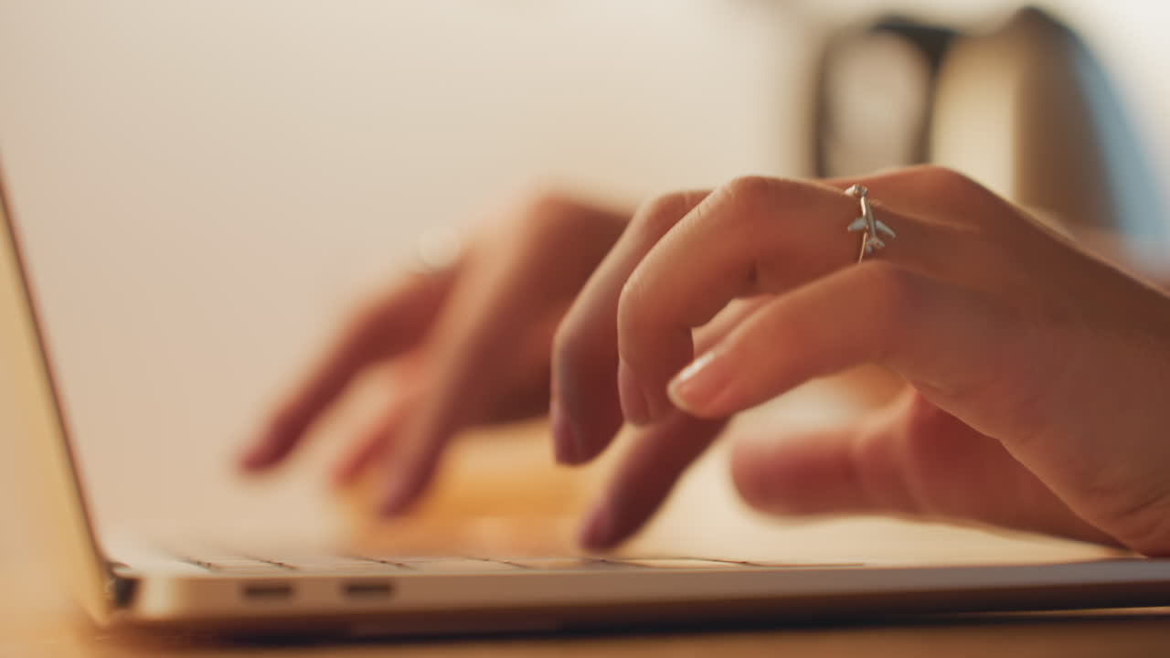 Traveler quickly writes checkout details. Individual rapidly documents checkout while packing efficiently. Someone hurriedly types message on laptop as they pack and prepare to leave hotel