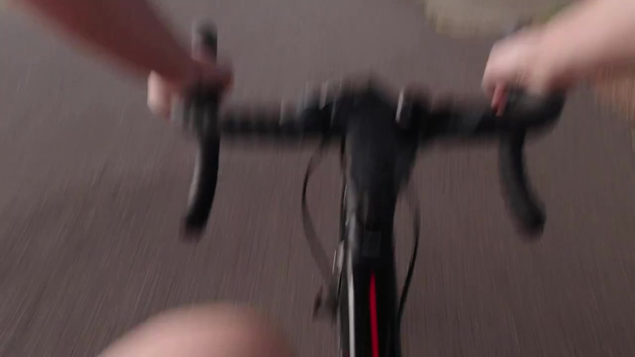 Commuter cycling in West London park with a chest mounted action camera