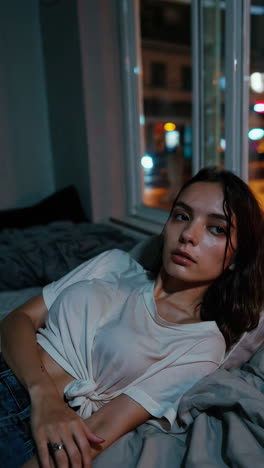 woman sleeping by a window at night