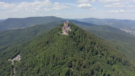 approaching aerial shot of a renovated medieval castle in the alsace region of france