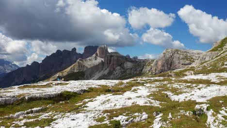 aerial flying over rocky landscape with view of the sexten dolomites in background