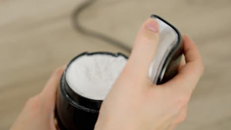 opening a machine to turn regular sugar into powdered sugar for making tiramisu dessert