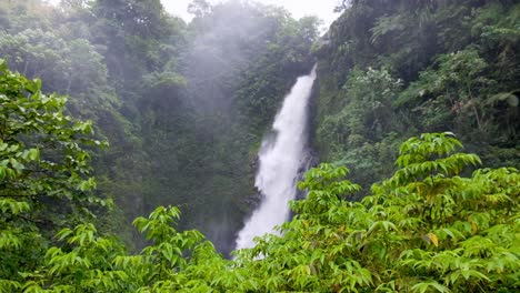 scenic view of togarau waterfall with heavy fast flowing water in wakunai mountainous region of central bougainville island, papua new guinea