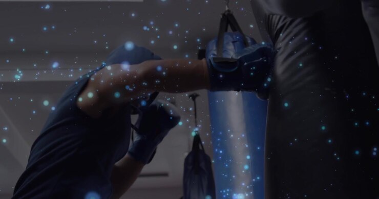 Man reaching gloved hand to bag starting boxing landing jabs hooks trainer holding blue dots moving