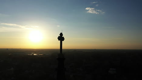 An-aerial-shot-of-a-cathedral's-steeple,-taken-at-sunrise