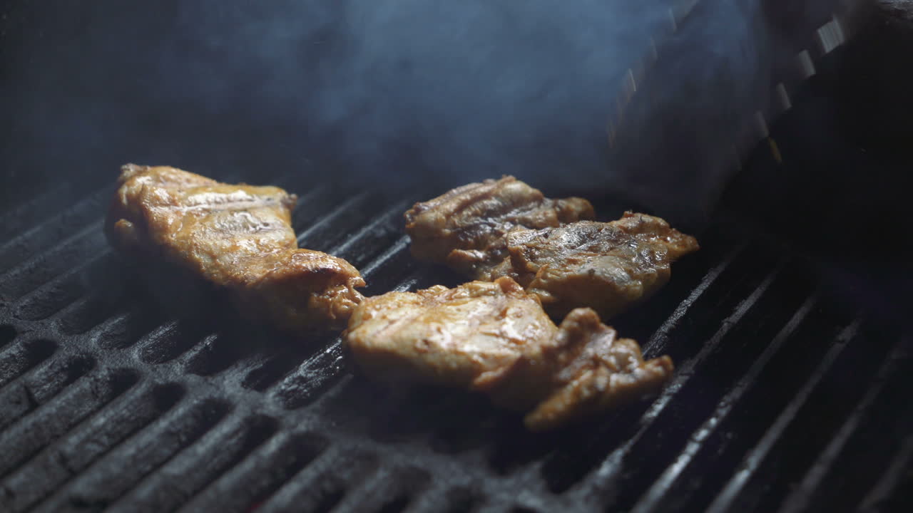 Preparation of delicious succulent meat steaks on the grill. Barbecue from charcoal.
