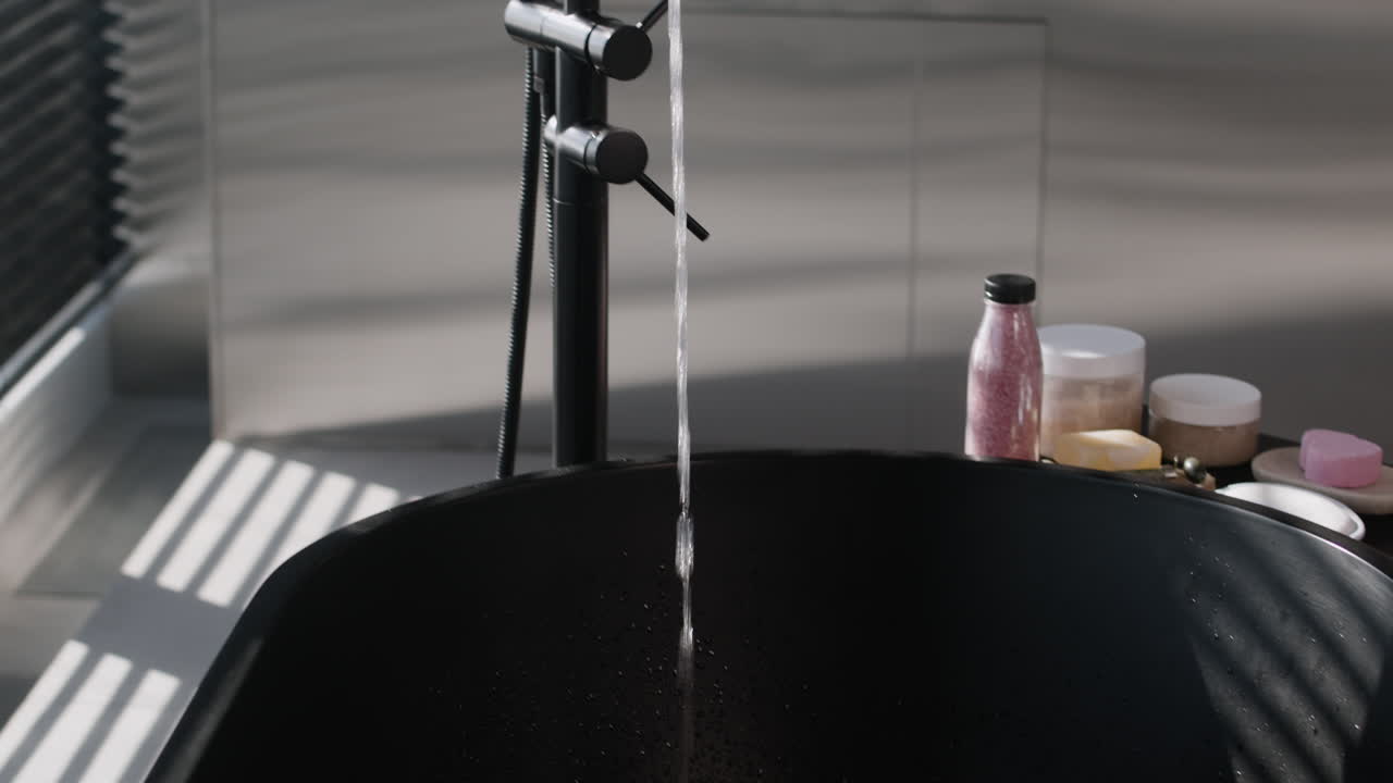 Modern Black Bathtub with Water Flowing
