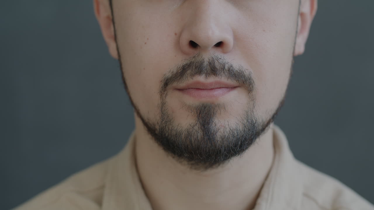 Close-up of a man smiling with a beard