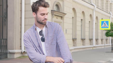 stylish man walking on city street