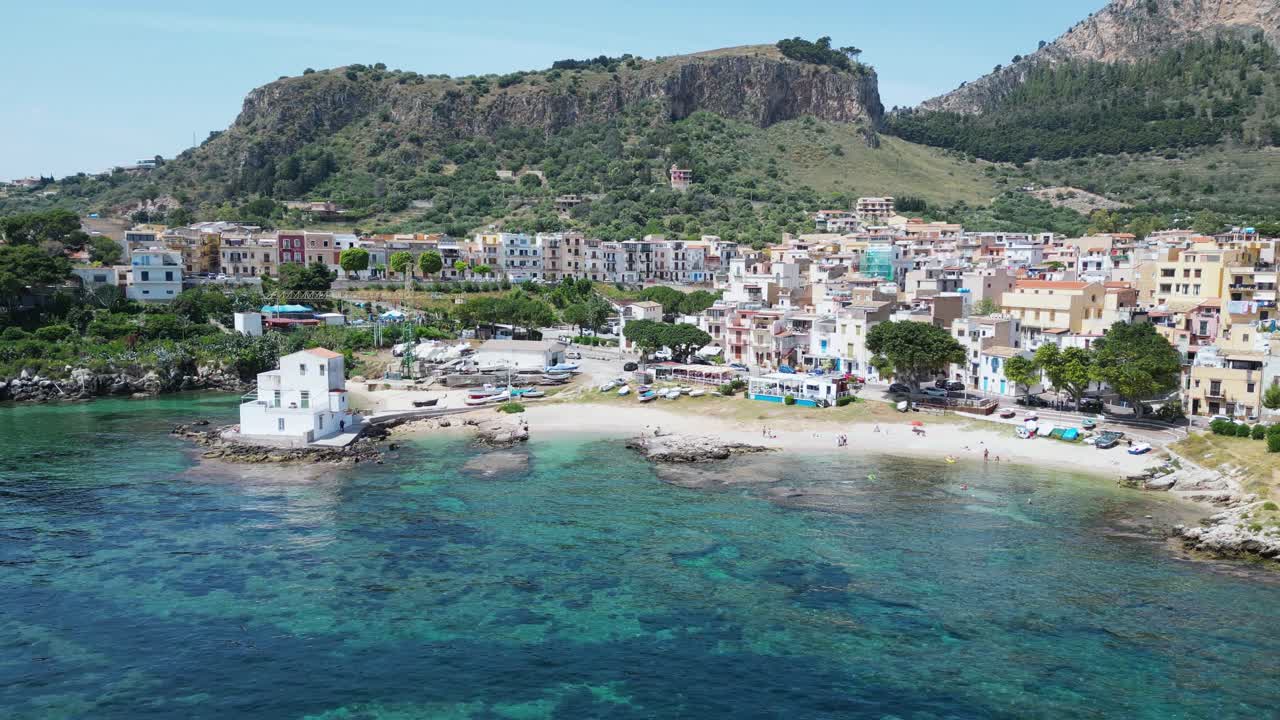 Aerial drone footage of Sant’Elia cove in Sicily: turquoise sea, rocky coastline, hidden beach, and Mediterranean charm. Perfect for travel, nature, and summer holiday projects