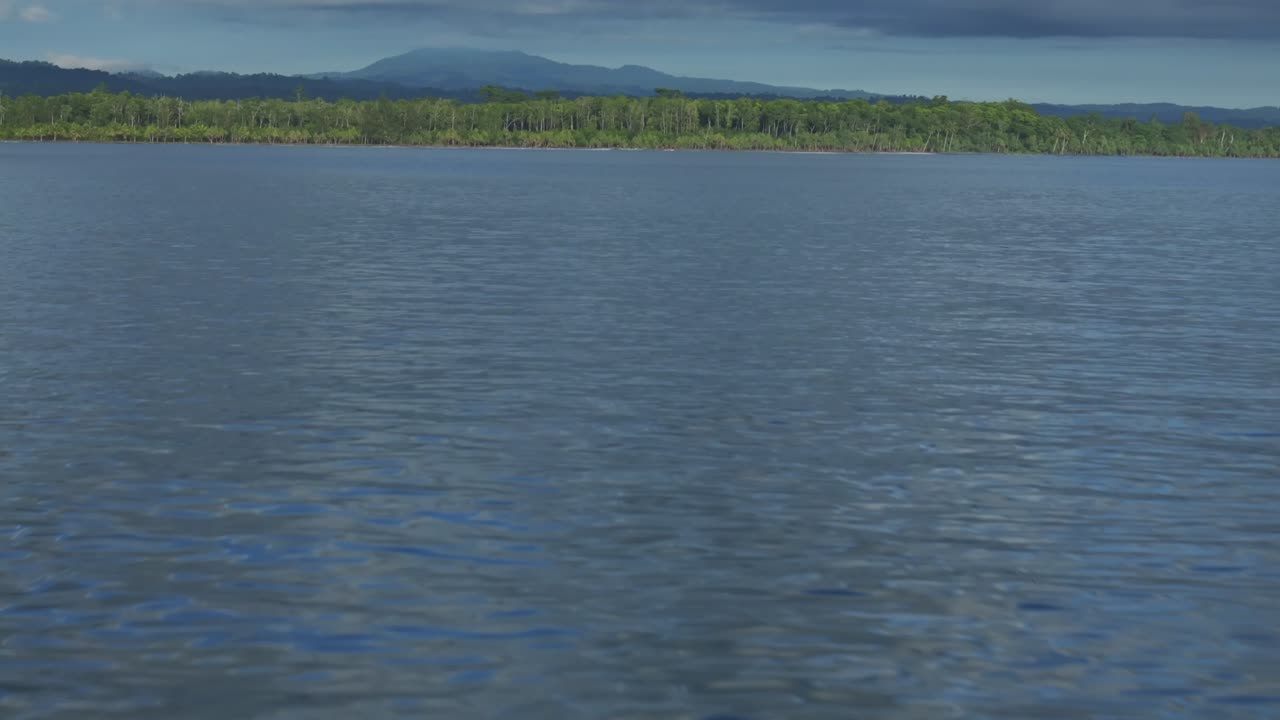 Wewak sea harbour view Wewak Hill Cape Wom Dogreto aerial drone Papua New Guinea Pacific Ocean pristine remote tropical jungle untouched beach coastline sunny dry season blue sky morning forward pan