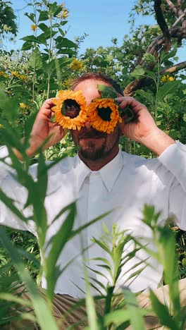 man wearing sunflower glasses in a garden