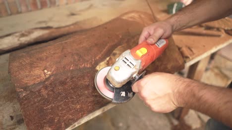 carpenter working sanding with woodworking machines in carpentry shop