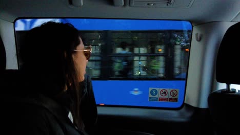 una mujer mirando el tranvía a través de una ventana de taxi en cracovia, polonia