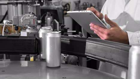 quality supervisor or technician is inspecting the automated production at a beverage factory. close up shot of employee using tablet computer for work. high quality 4k footage